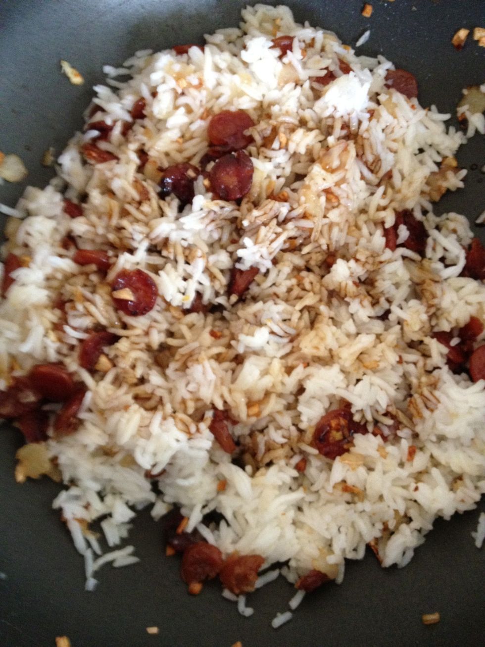 Add the thick soy sauce and soy sauce to the rice mixture. Stir well to ensure the rice are well coated with the sauces