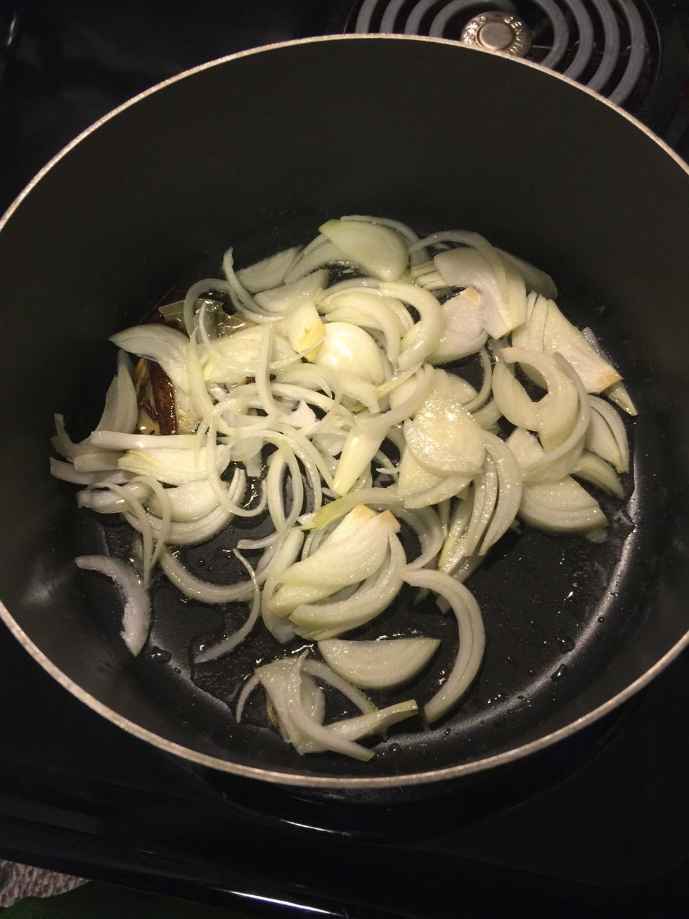 Add the thinly sliced onions and cook, till they start browning.