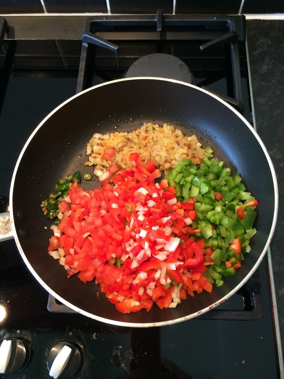 Add the tomato, chillies and capsicums