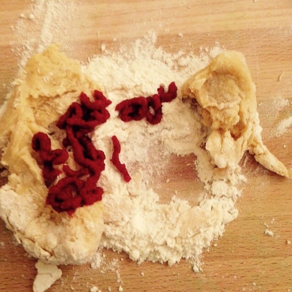 Add the tomato concentrate to another third of the dough and knead until homogeneous.