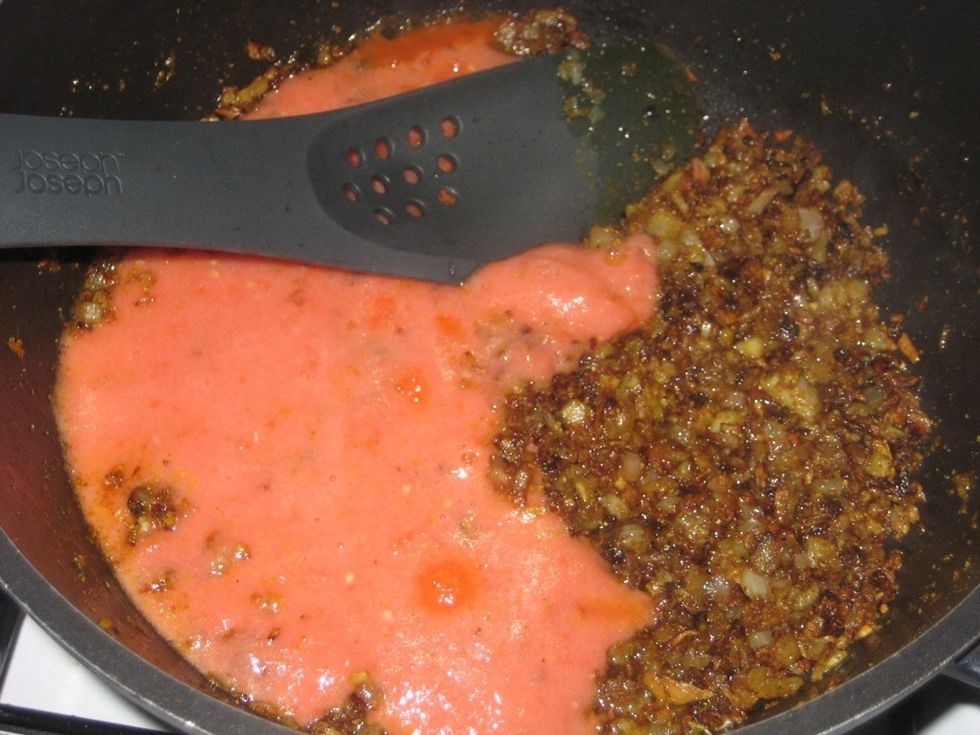 Add the tomato juice to the nice golden brown onion.