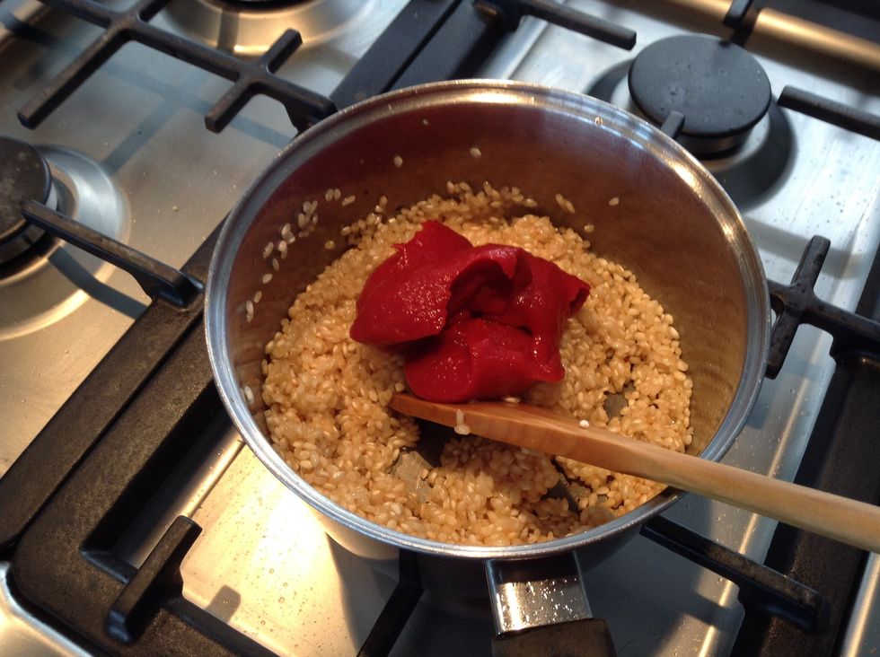 Add the tomato paste to the rice.