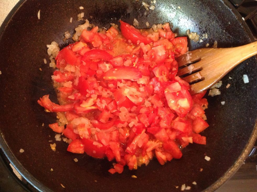 Add the tomatoes and the garlic in
