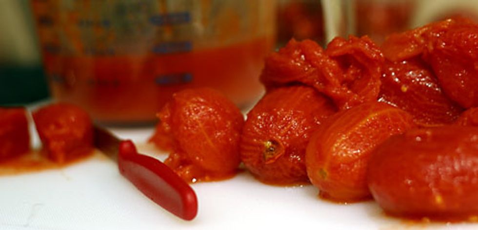 Add the tomatoes (crushing with your hands as you add them) and their liquid.