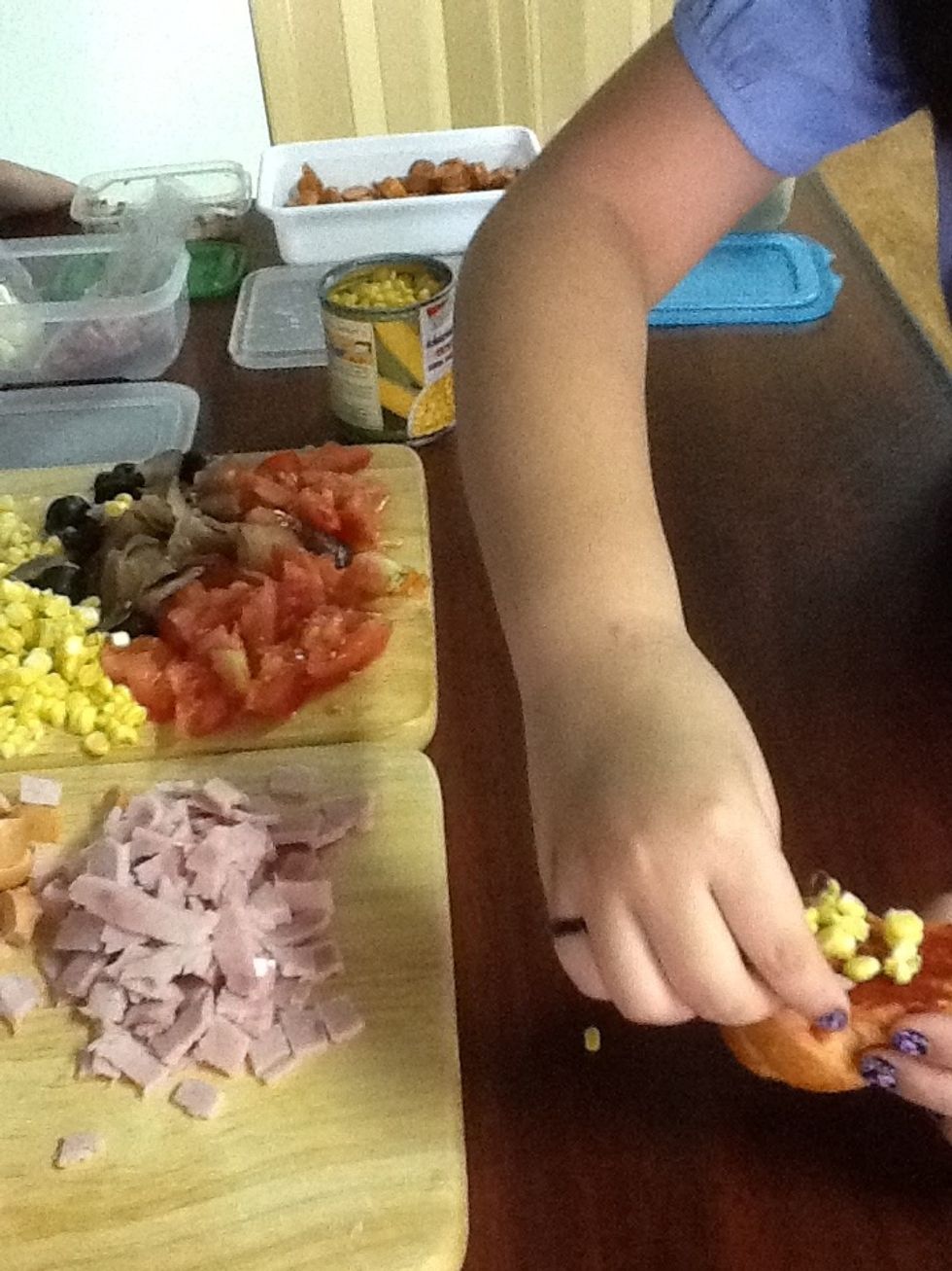 Add the toppings to the mini pizza.