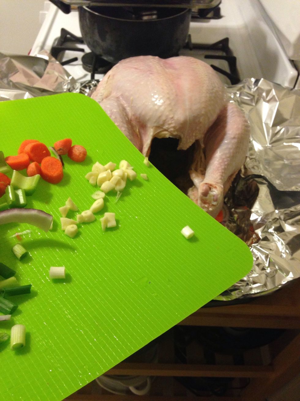 Add the turkey to the pans and add remaining veggies to inside the turkey.
