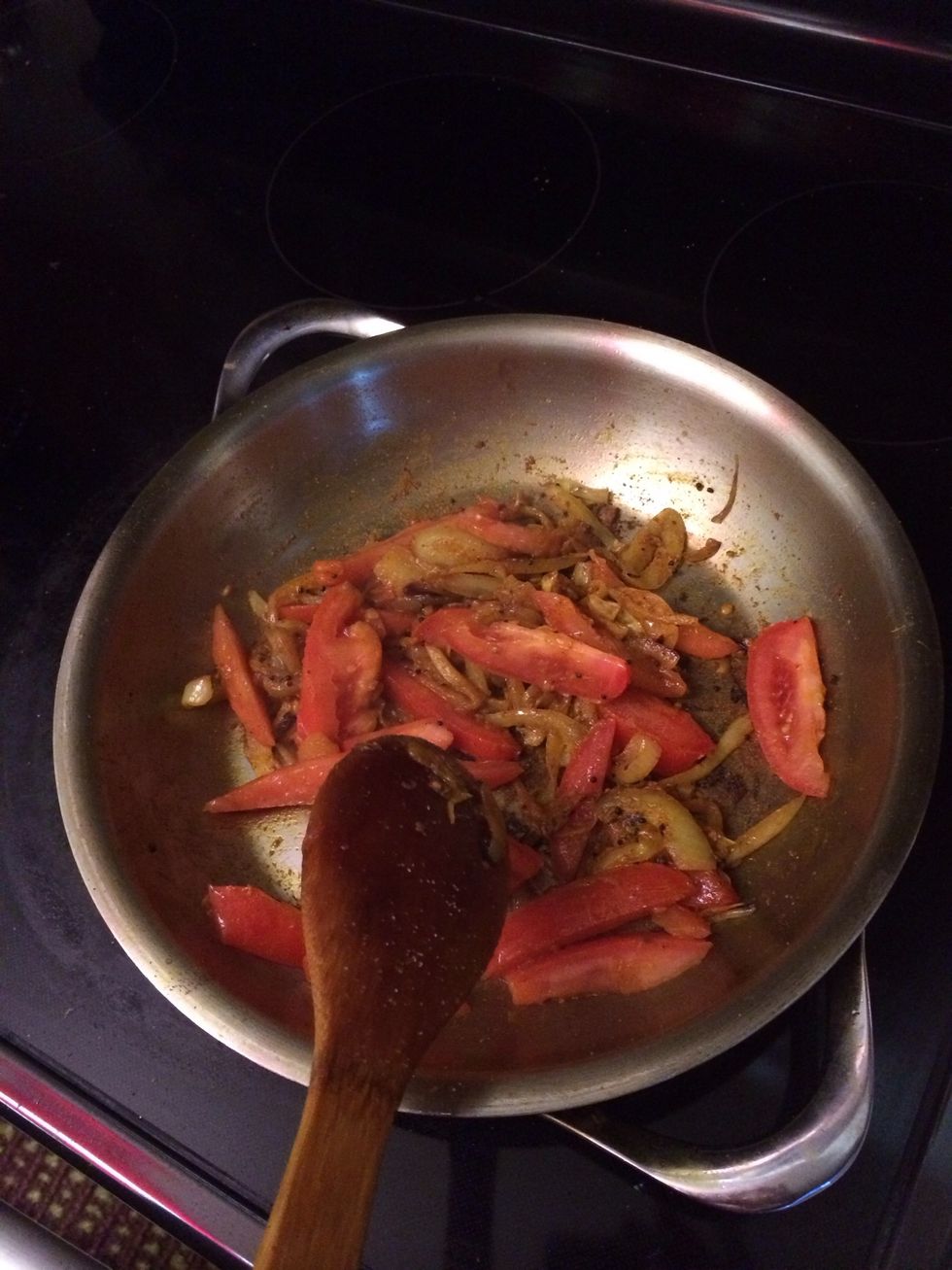 Add the turmeric powder, chili powder, cumin powder.All the powders and spices you want to be honest (1 tbs each). And then pour the tomatoes in.. Stir till onion looks brown and tomatoes look cooked.
