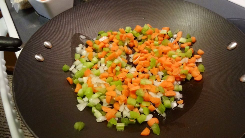 Add the vegetables to the wok and saut\u00e9 for about 3 minutes.