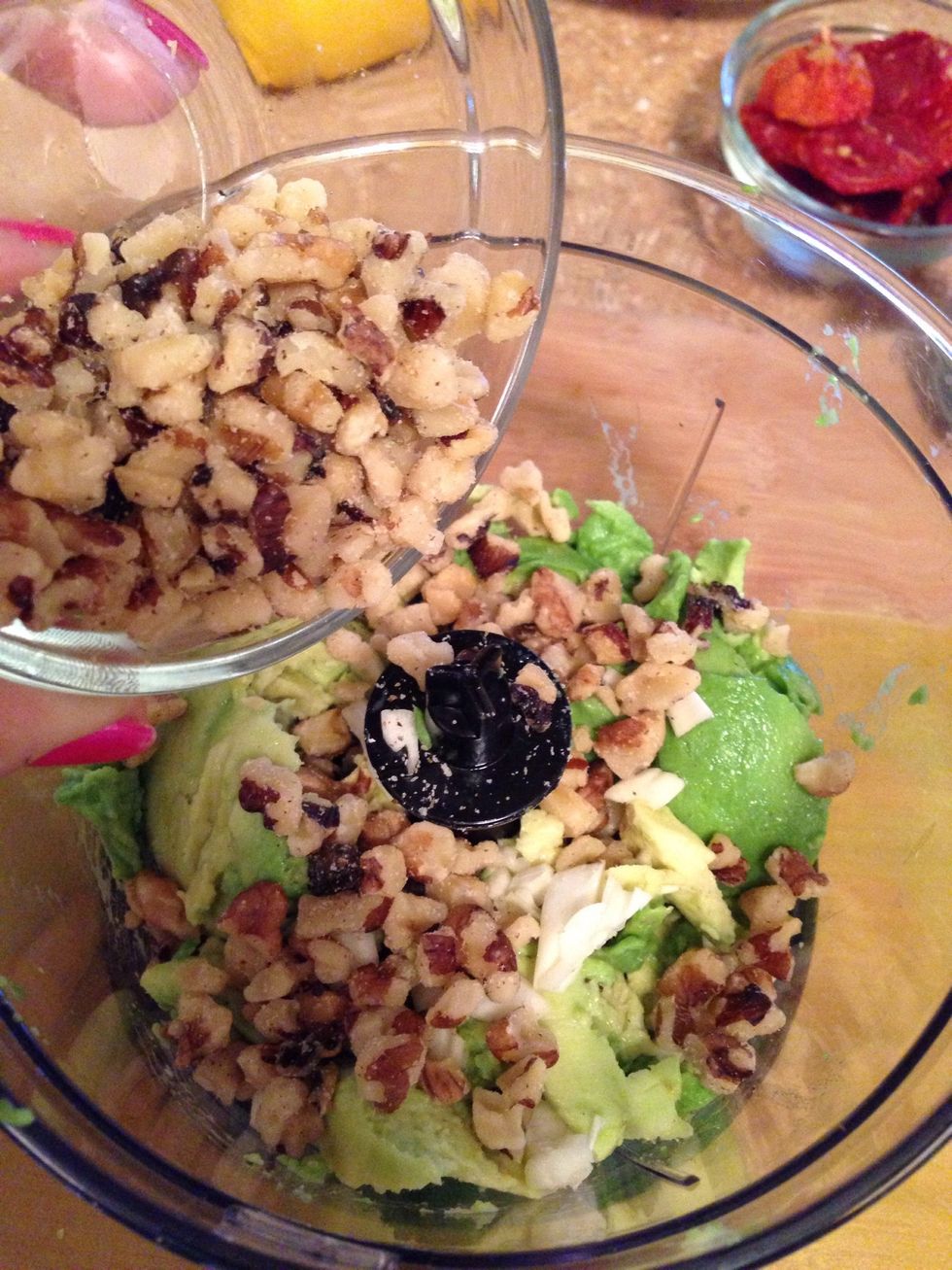 Add the walnuts. Usually pesto is made with pine nuts (pignoli in Italian!), but you can use other nuts too like almonds, walnuts, & pecans. I didn't have pine nuts so I decided to try walnuts.