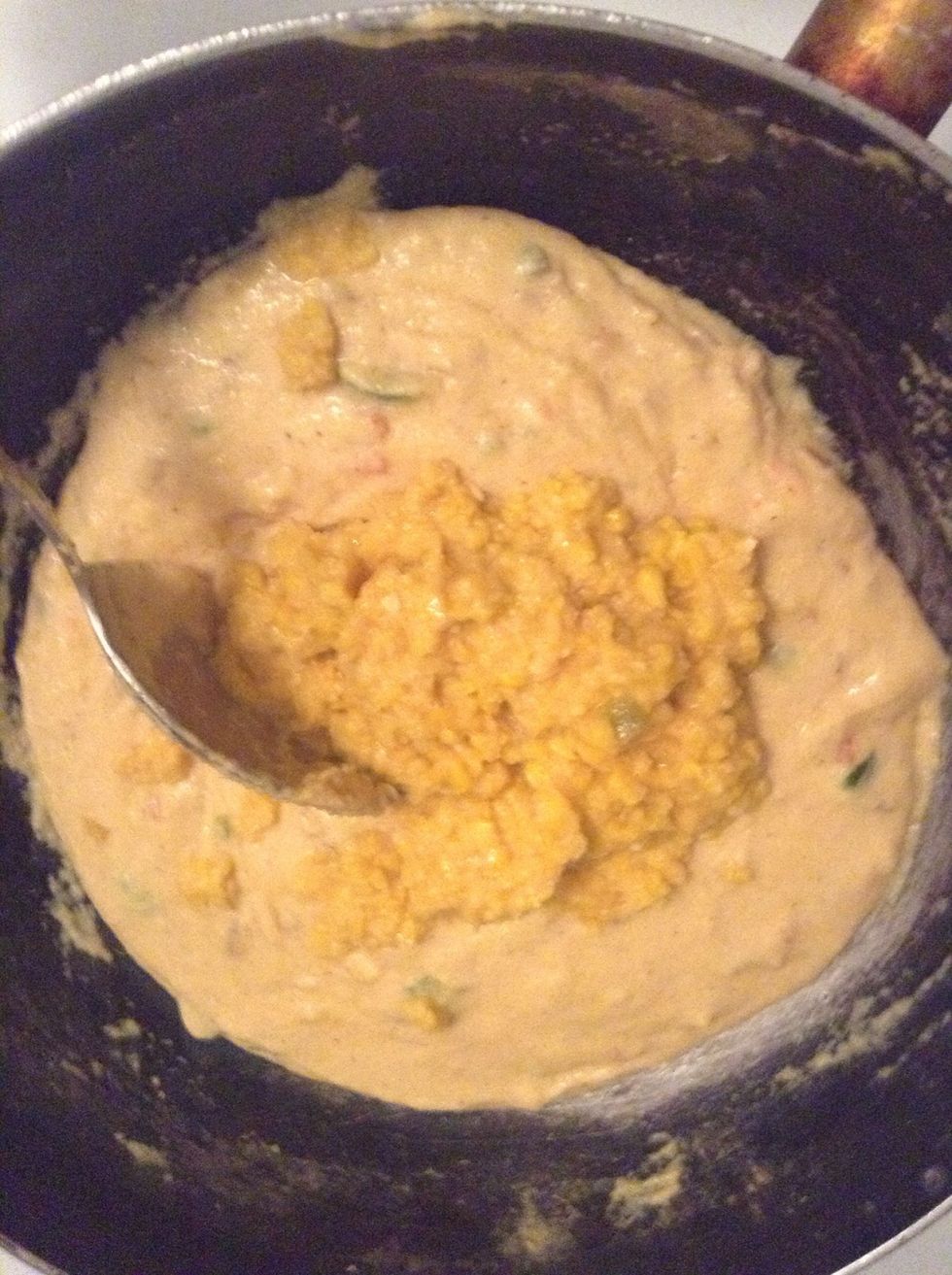 Add the whole corn and stir to mix. Let the mixture continue to cook on low heat until it comes away easily from the sides of the pot
