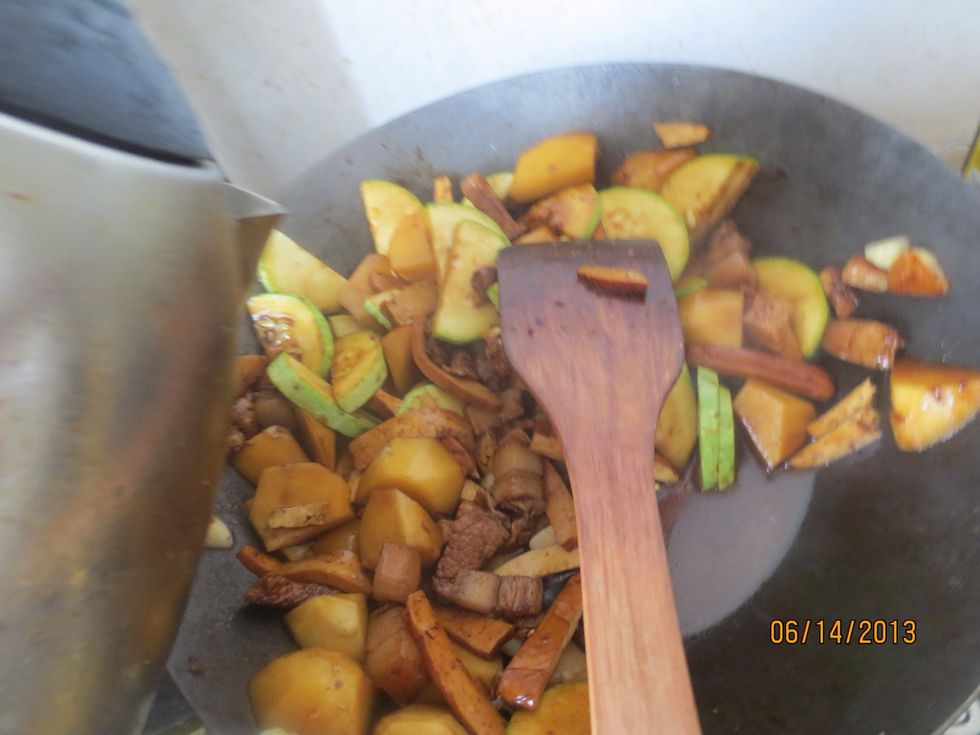 Add the zucchini and tofu and stir fry. Add water.
