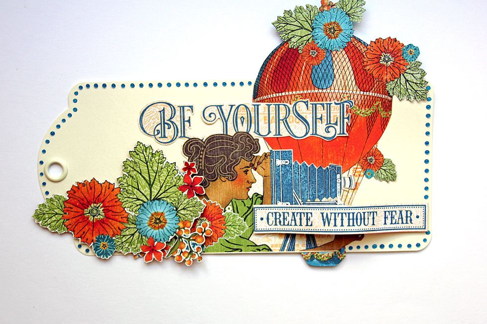 Add these images on top of the balloon. Add the "Create without Fear" sentiment using dimensional foam adhesive. Trim the outer edge of the tag using a gel pen.