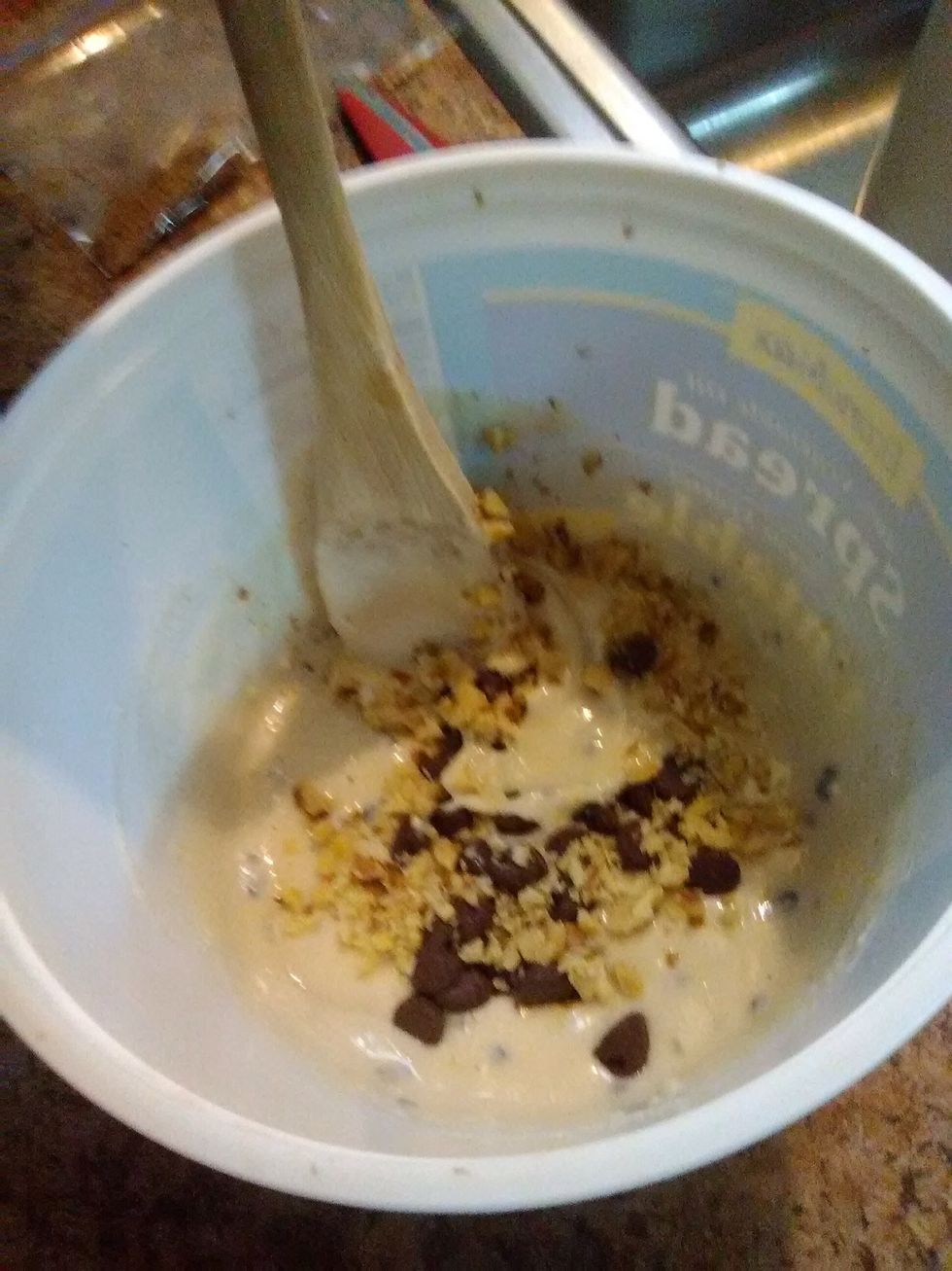 Add thirty chocolate chips and some chopped walnuts to the mixture and stir
