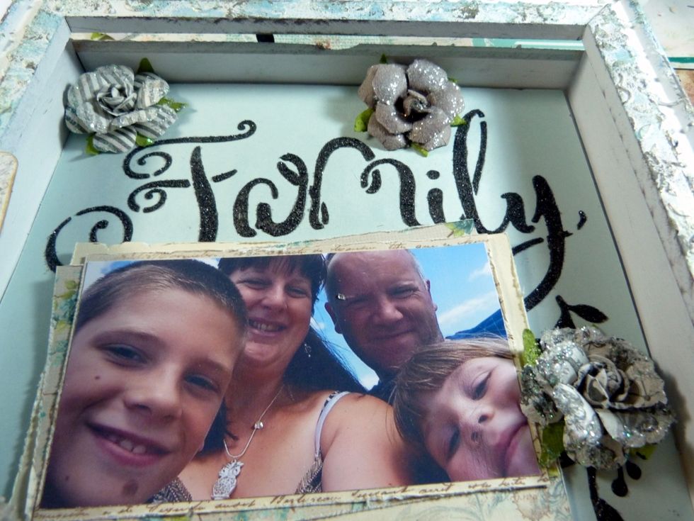 Add three more flowers to the inside of the shadow box like in the photo.