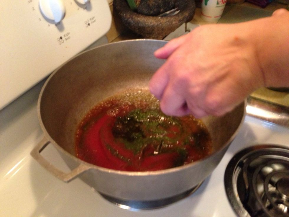 Add three tablespoons of Abuela and the can of tomato sauce