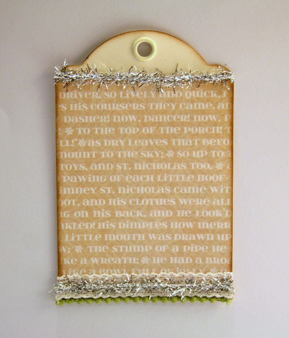 Add tinsel trim to top of tag and to center of lace.