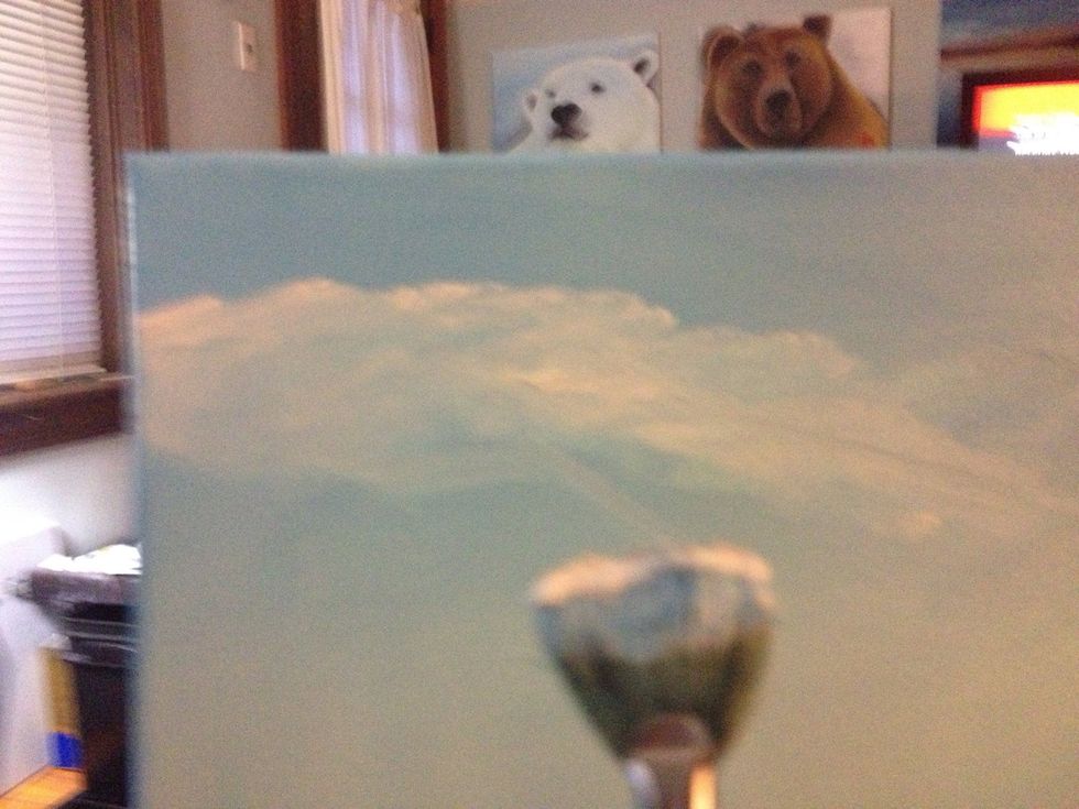 Add titanium white to your fan brush and add random cloud patterns like so.