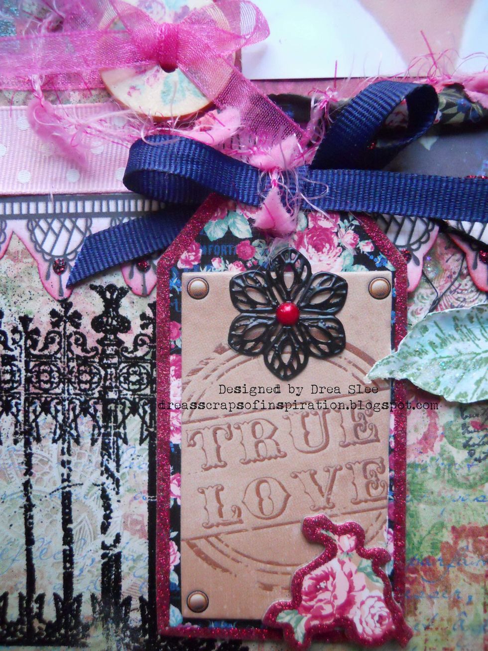 Add title tag to the right of the embossed fence. From the Ephemera I used the black metal flower and black ribbon, adding some pink fiber from my own stash.