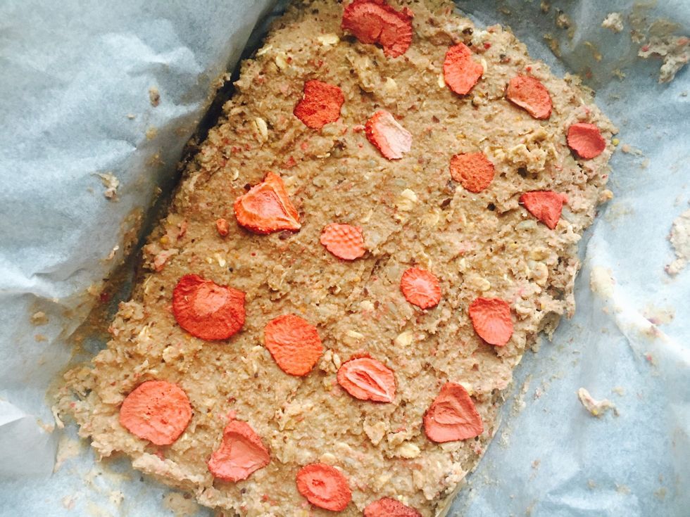 Add to the baking tray. Decorate with some dried strawberries on top. Press down and form into a square shape. Freeze for 1-2 hours.