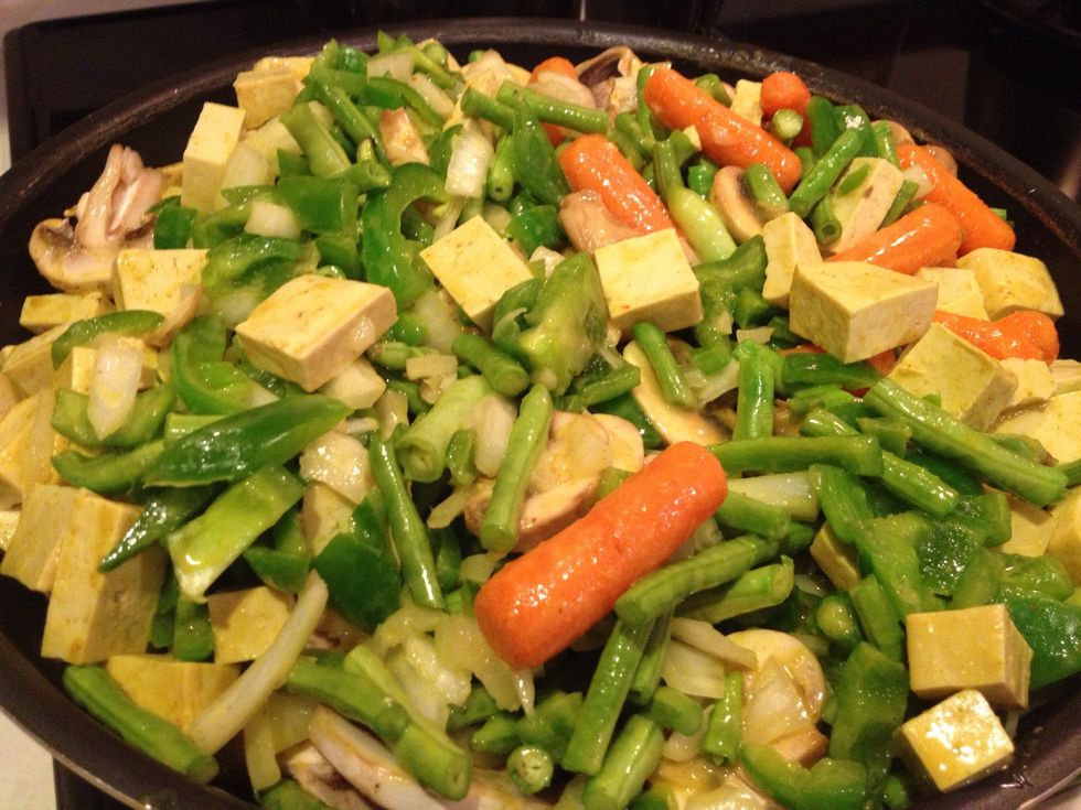 Add tofu and vegetables, bring to a boil, reduce heat to simmer, and cook for 10-12 minutes, or until vegetables are crisp-tender.
