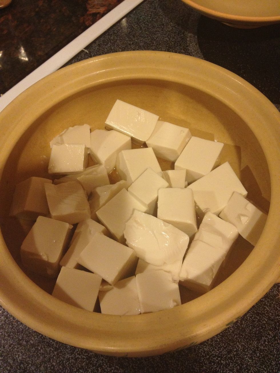 Add tofu to clay pot, gently fry with the sesame oil and set aside.
