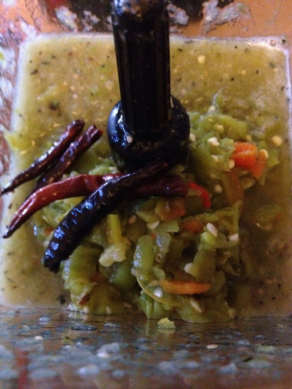 Add tomatillos, hatch chiles, chiles de arbol and garlic to blender with 1/4 chicken stock. Liquify.