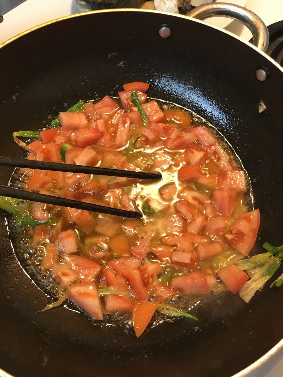 Add tomato, 1 tsp of brown sugar, and 2 tbsp of fish sauce