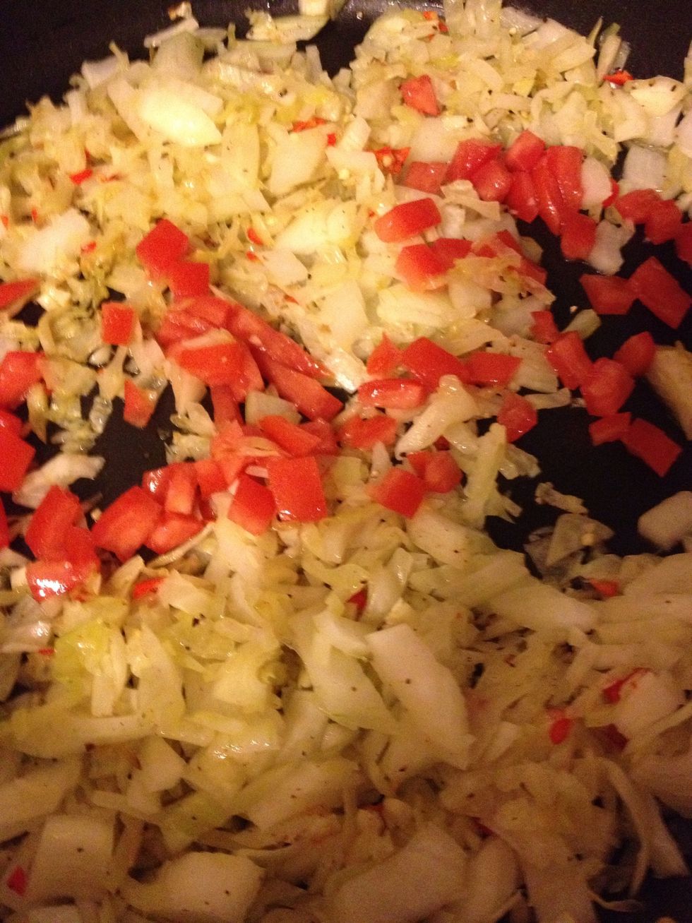Add tomato once onions and cabbage are wilted... Cook, covered, for a few more minutes.
