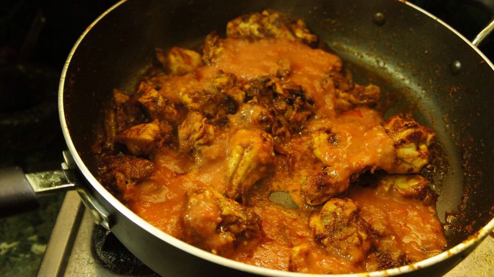 Add tomato pur\u00e9e to the cooked chicken...and cook for 5-10 min