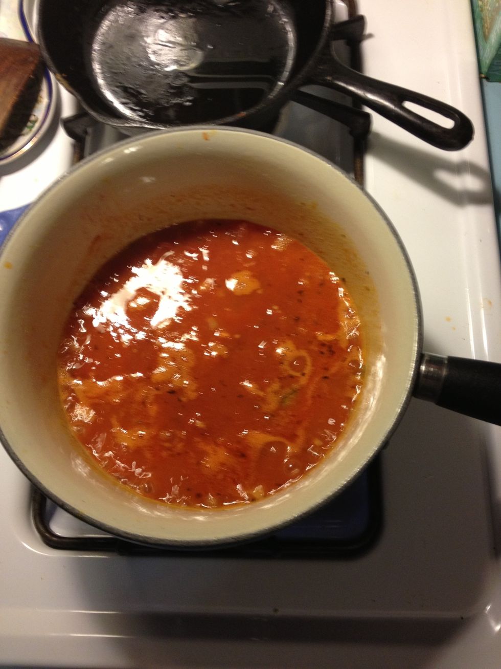 Add tomatoes and sauce to a sauce pan and heat until a small boil. Cook to reduce slightly