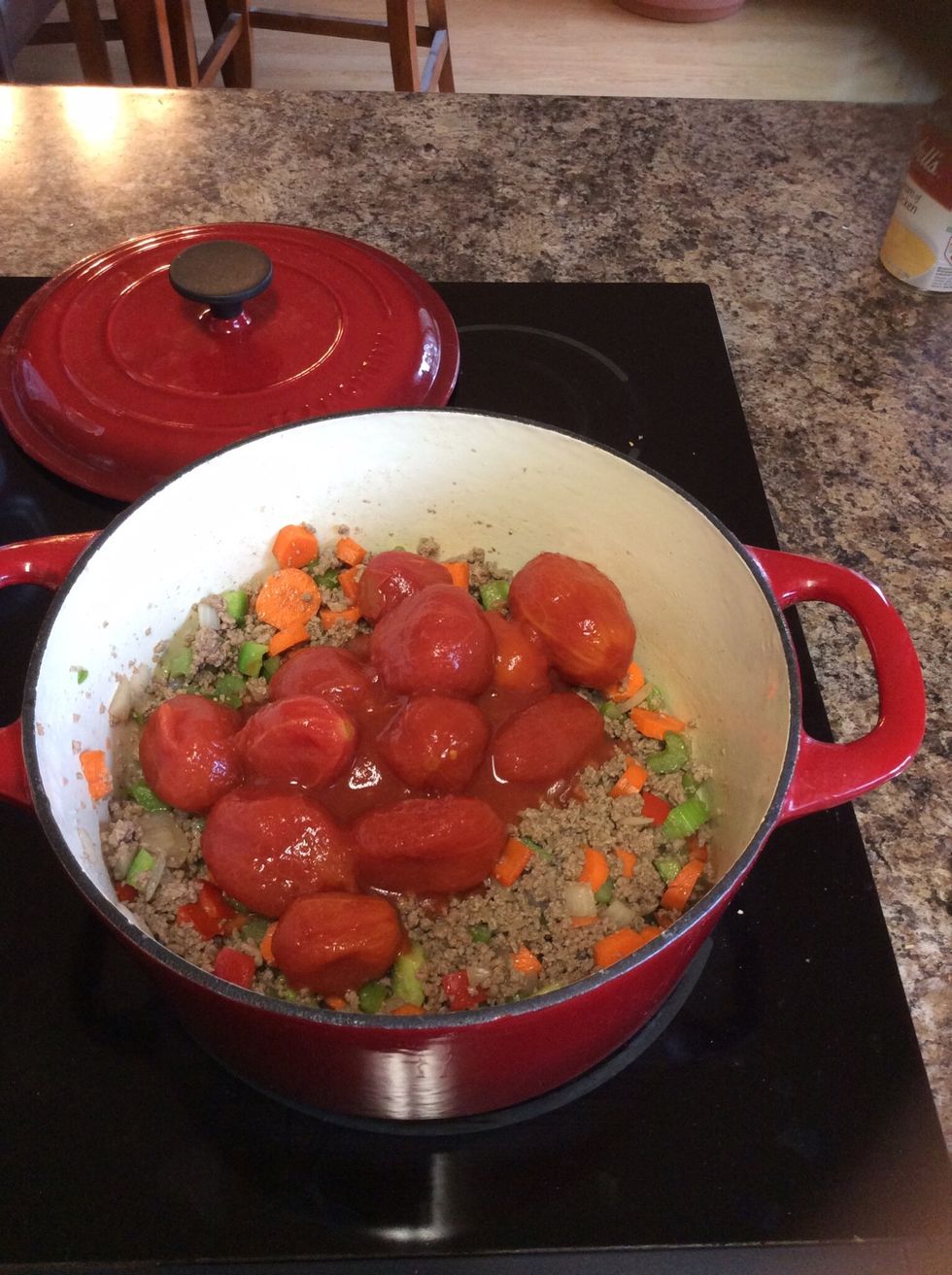Add tomatoes, smoosh with potato masher or hands.