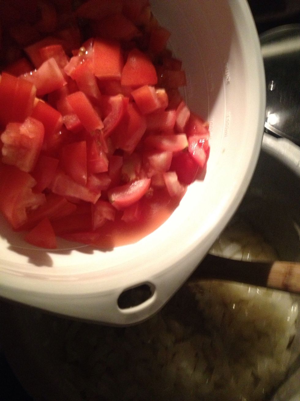 Add tomatoes to pot once onions are soft