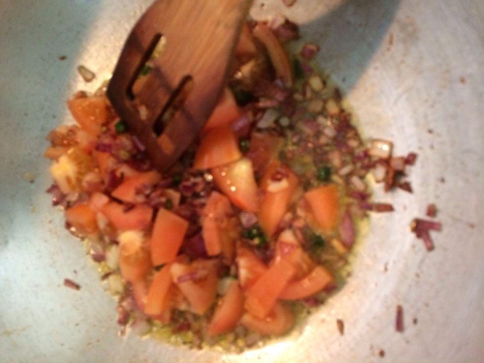 Add tomatoes when onions are cooked
