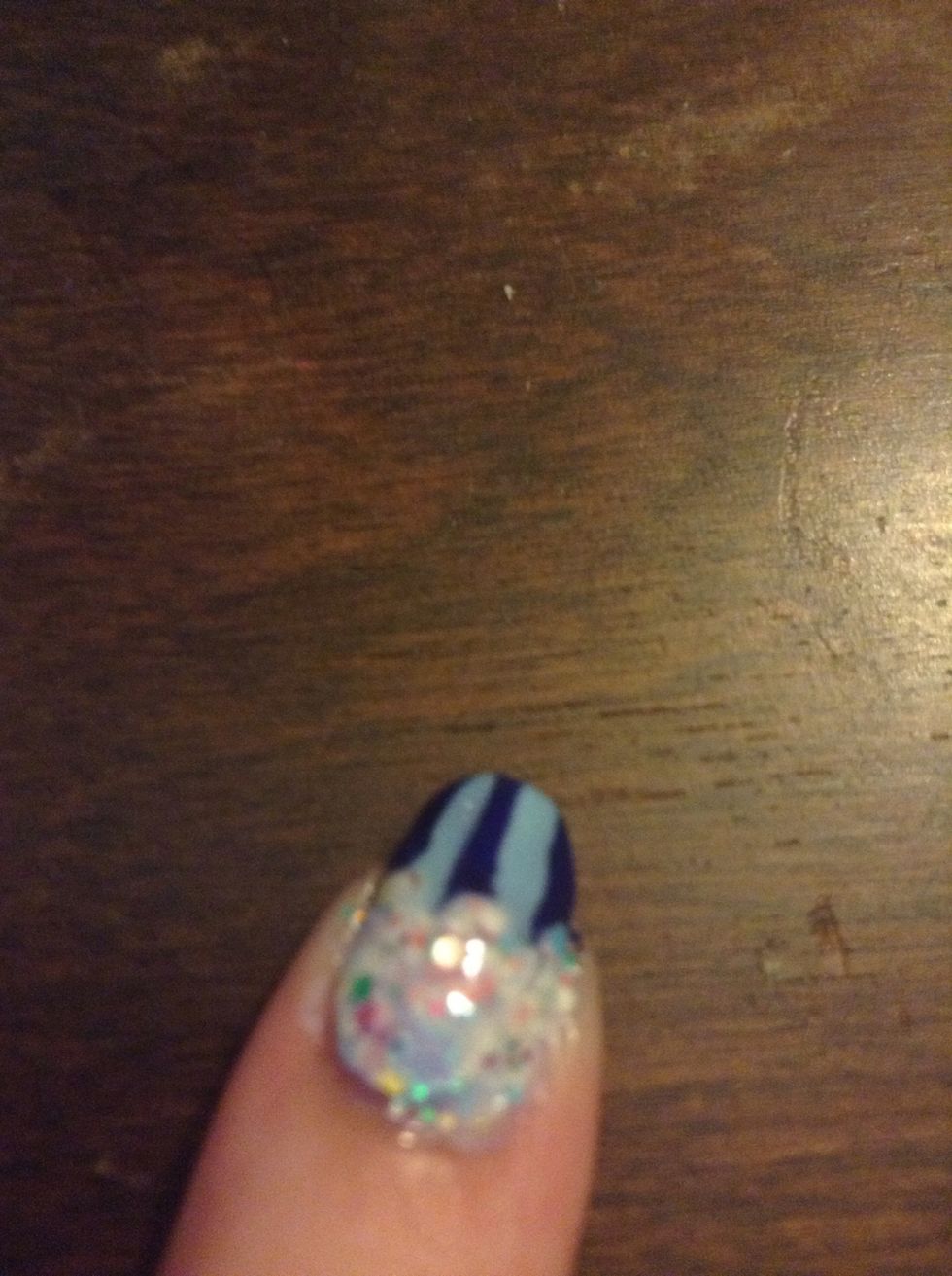 Add topcoat and clean up with polish remover and a small brush it q-tip.