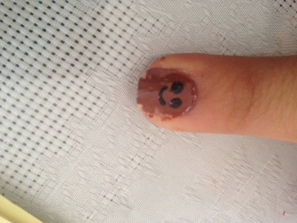 Add two black dots and his smile on the cookie nail.