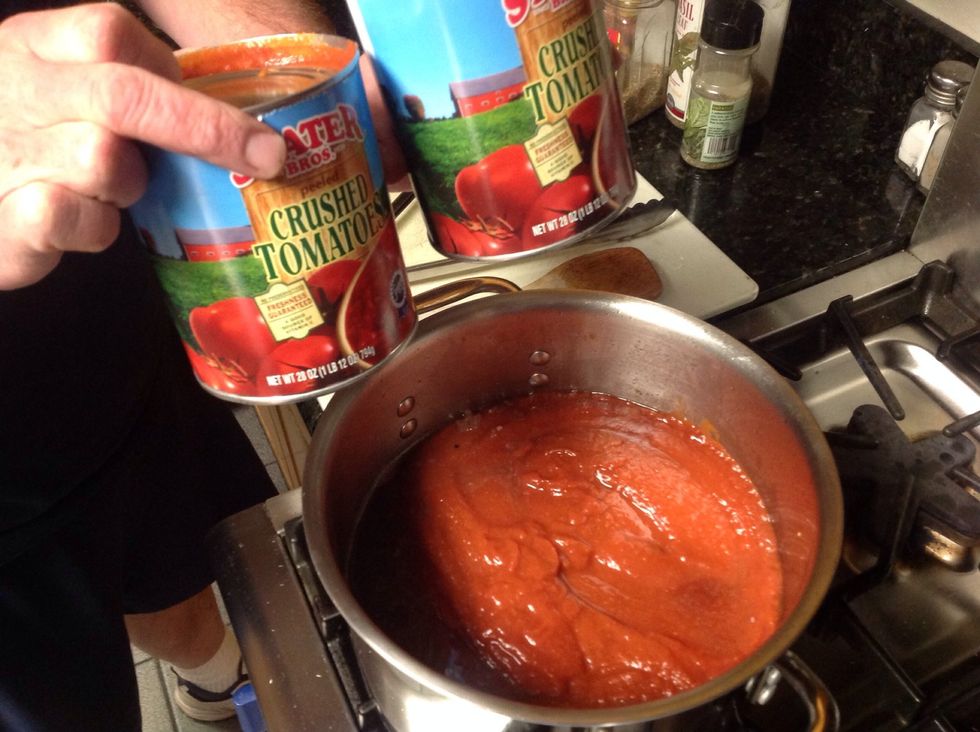 Add two cans crushed tomatoes.