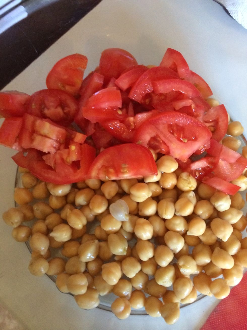 Add two chopped tomatoes to chickpeas