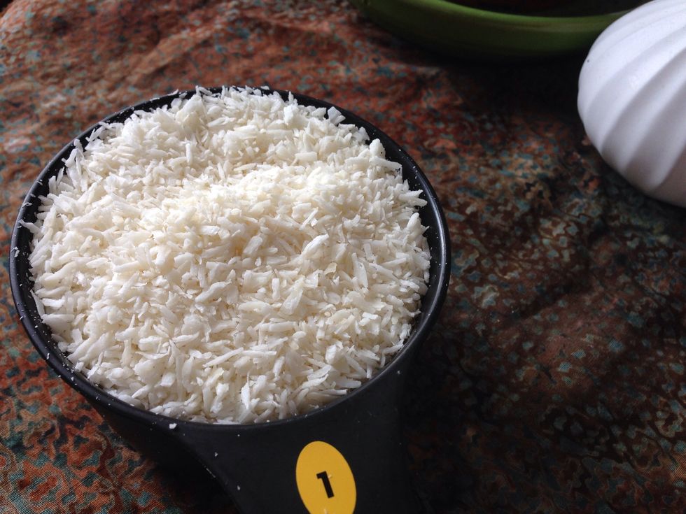 Add two cups raw shredded coconut (can be found in the bulk section at your local natural food store) to your food processor.
