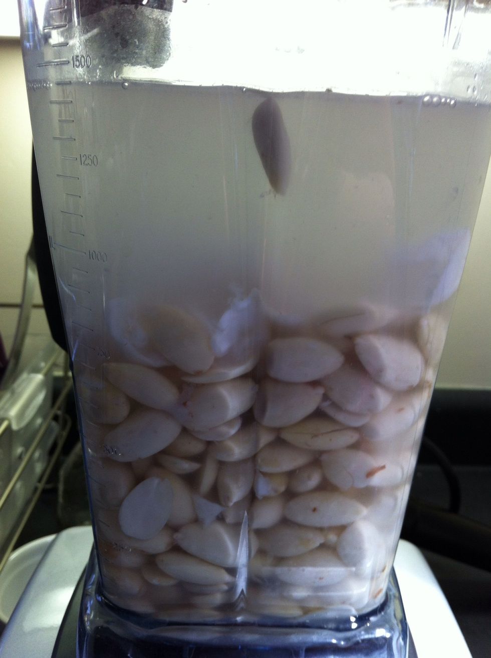 Add two cups water to one cup of almonds (pre soaking). Add coconut water from two coconuts (about 2-3 cups). Blend, I'm using a vitamix.