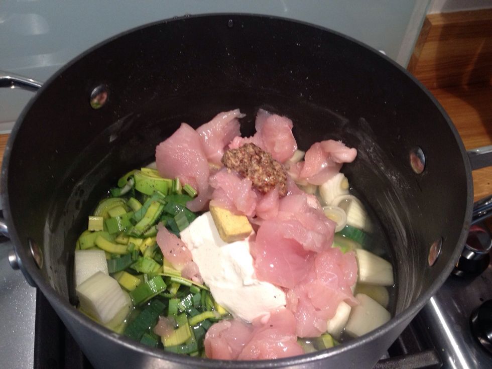 Add two diced chicken breasts, a heaped teaspoon of whole grain mustard and a wine glass worth of water. Place on the heat and stir well