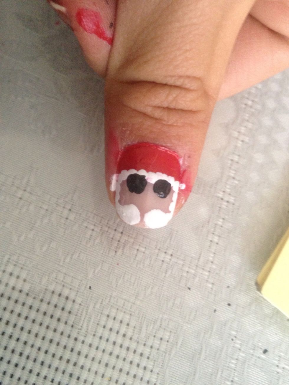 Add two dots for santa's eyes.