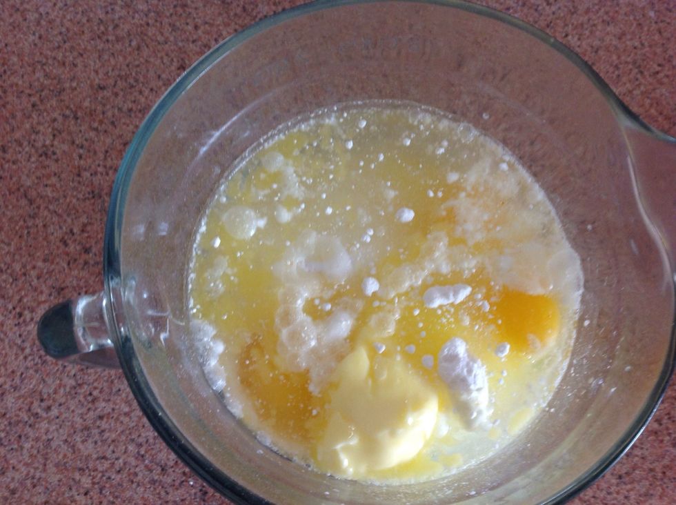Add two eggs, melted butter, cake mix, 1 cup of water, and 1 cup of flour.
