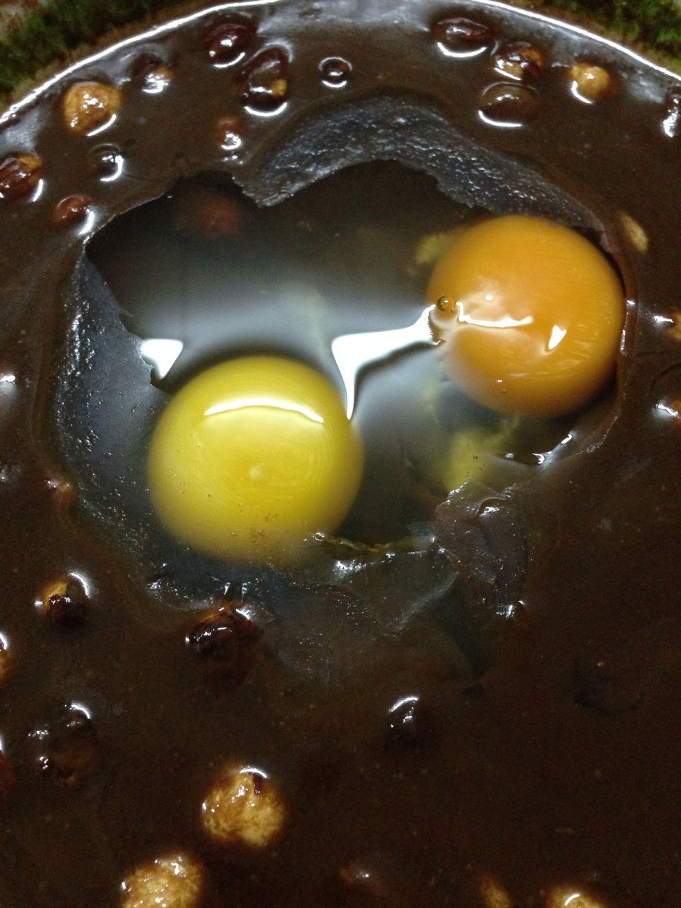 Add two eggs to the chocolate mixture