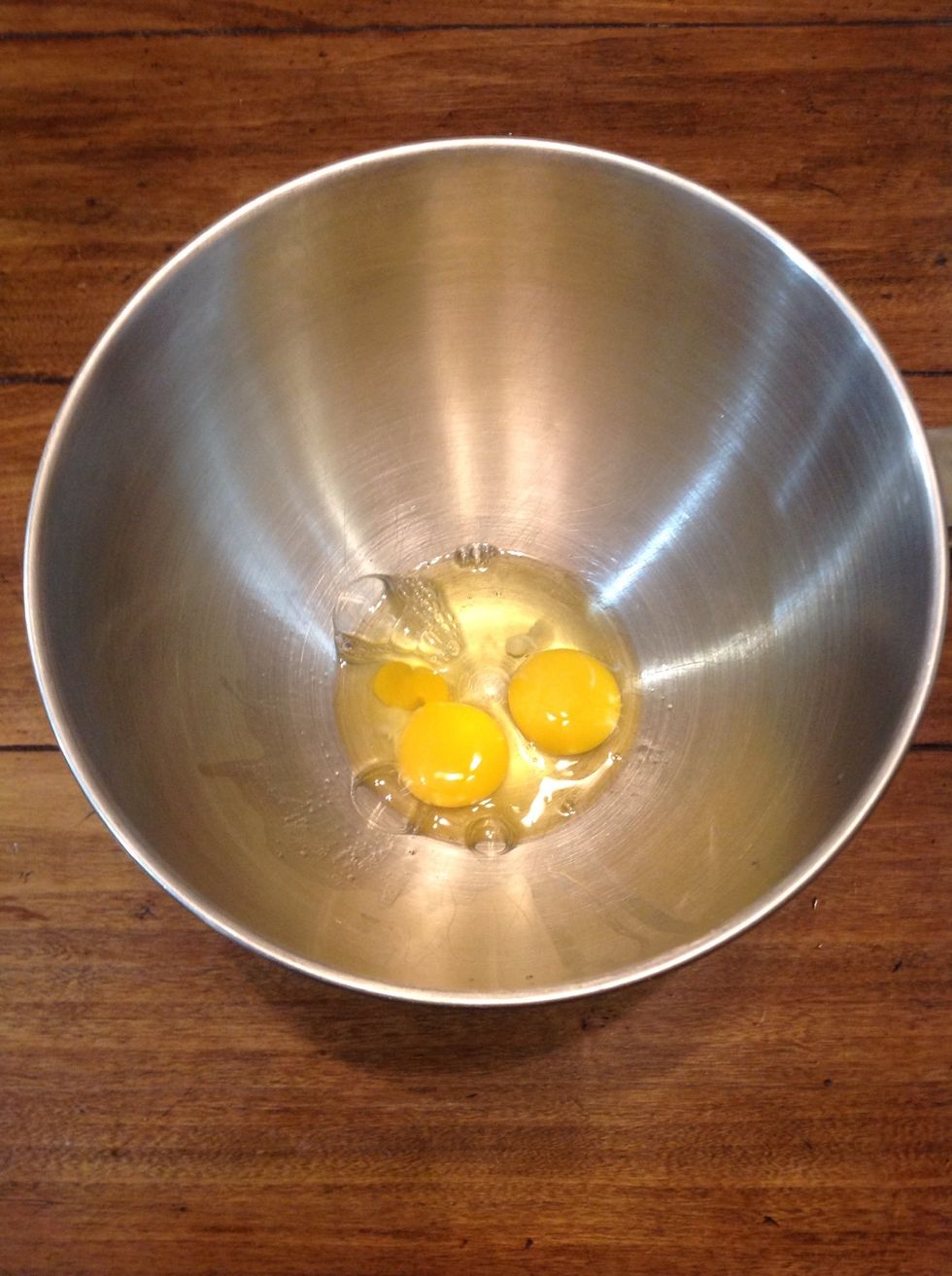 Add two eggs to the mixing bowl
