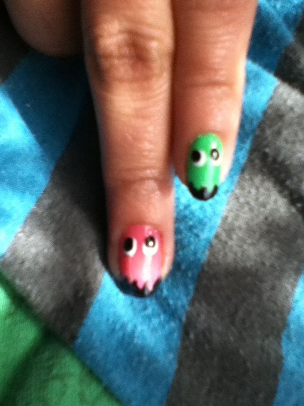 Add two large circles with a dotting tool and inside of the white ones add black circles to make the eyes