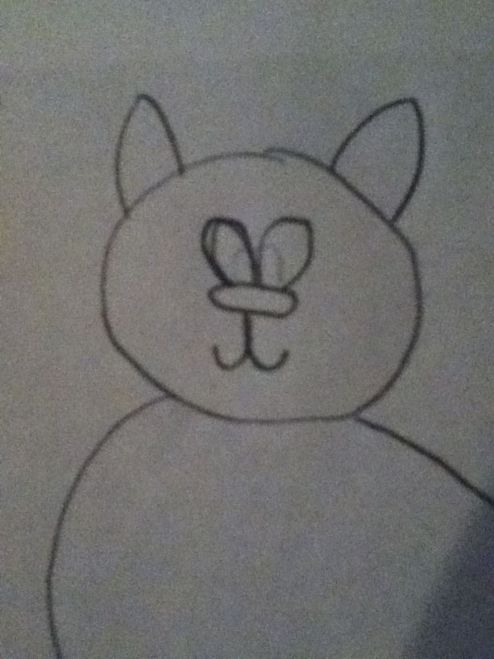 Add two lumps/oval/egg shaped eyes over the nose and add u shaped things under the nose ,