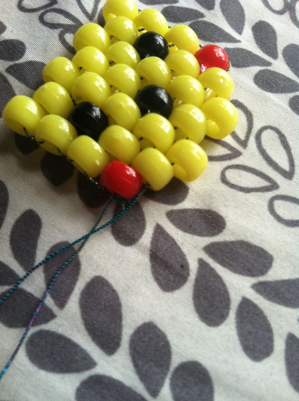 Add two more beads and tie the knot.
