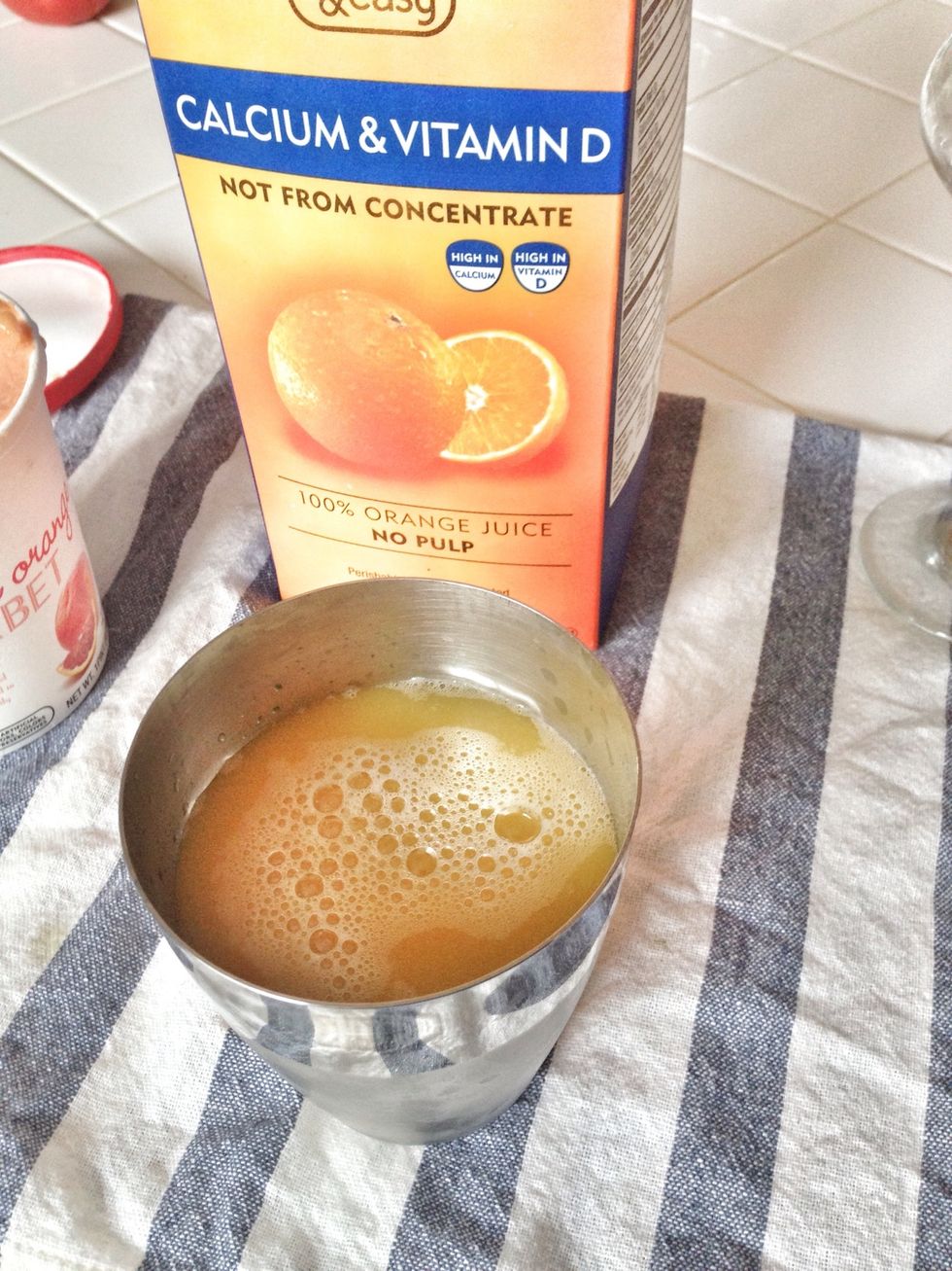 Add two parts orange juice. Place cap on cocktail shaker and shake for 30 seconds.