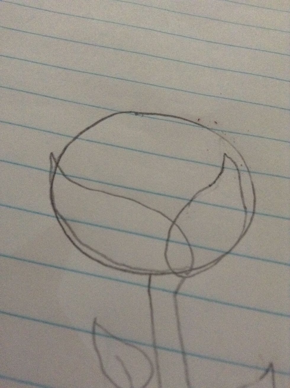 Add two shapes that look similar to the leaves inside the circle like so.