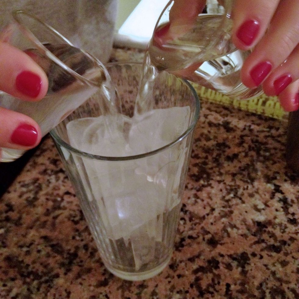 Add two shots of rum to a glass of ice. I also like this drink with vodka or whiskey...